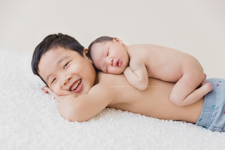 婕綝媽麻的三寶來拍新生兒寫真，這張是三寶趴在哥哥身上的相片！