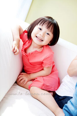 Iris&Lucas和爸拔媽麻回台度假時，帶了爺爺奶奶一起來拍照，這張是Iris的獨照，Iris很女生的模樣，穿著桃紅色洋裝坐在沙發上！