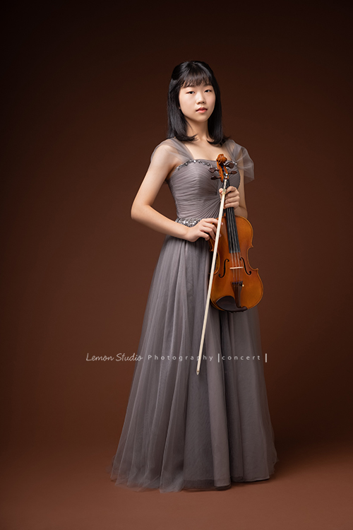 映萱是學校國中弦樂團的首席!很沈穩及自信的映萱為了即將來到的音樂會拍照,這張是映萱的全身照!