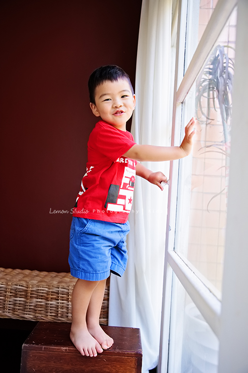 佳薇媽麻一家回台時來拍照，也趁著哥哥兩歲半、小妹十個月來拍寶寶寫真，外公外婆舅舅阿姨也一起拍全家福，這張是哥哥站在窗戶邊逗趣可愛的模樣！